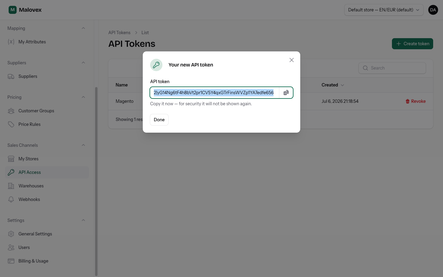 The dialog showing the full API token value once, with a copy button and a warning that it will not be shown again